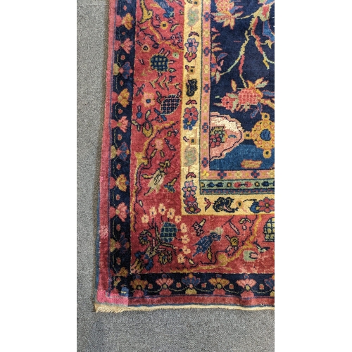 186 - A Khorassan Mashhad red ground carpet, circa 1930s, with field of stylised floral motif medallions,... 