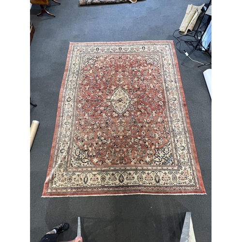 187 - A Sarouk carpet, with central medallion and field of foliate motifs on a brick red ground 430 x 320c... 