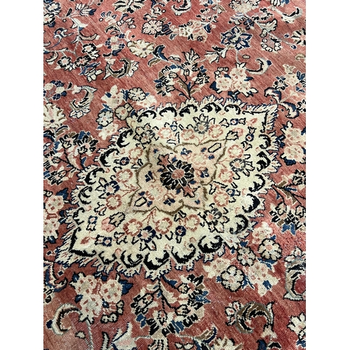 187 - A Sarouk carpet, with central medallion and field of foliate motifs on a brick red ground 430 x 320c... 