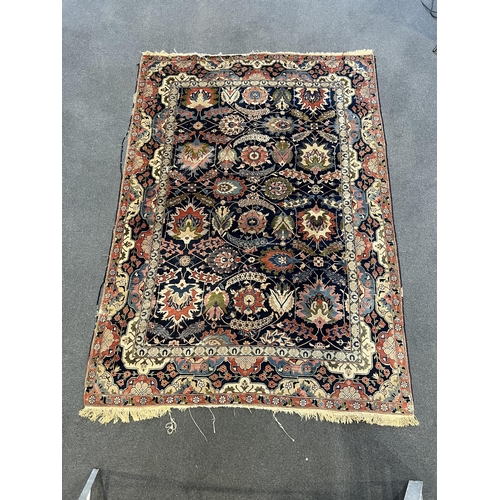 188 - An early 20th century Benlian Tabriz carpet, signed Mahmud, with foliate motifs on a black ground, 3... 