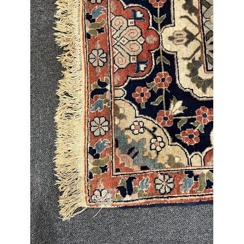 188 - An early 20th century Benlian Tabriz carpet, signed Mahmud, with foliate motifs on a black ground, 3... 