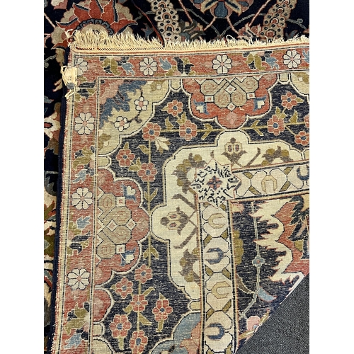 188 - An early 20th century Benlian Tabriz carpet, signed Mahmud, with foliate motifs on a black ground, 3... 