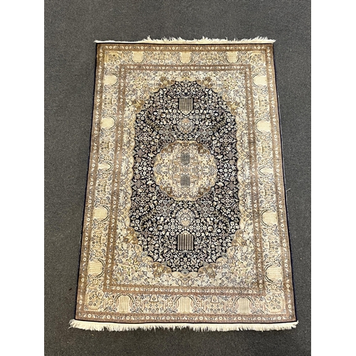 195 - A Persian silk rug, with central medallion and field of foliate motifs on a black ground, 180 x 120c... 