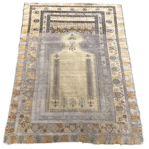 196 - A Turkish silk prayer rug, with mihrab and stylised foliate borders on a gold ground, 185 x 137cm... 