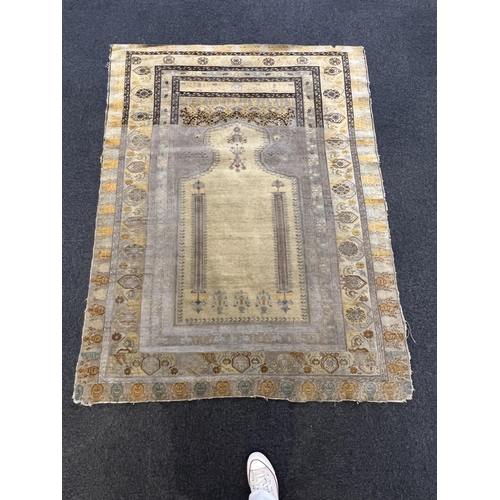 196 - A Turkish silk prayer rug, with mihrab and stylised foliate borders on a gold ground, 185 x 137cm... 