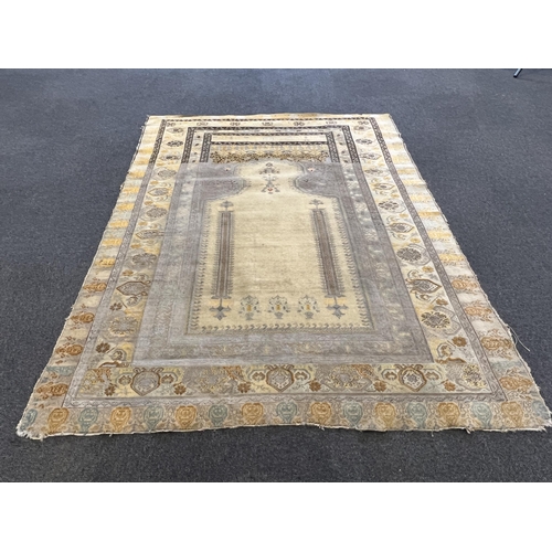 196 - A Turkish silk prayer rug, with mihrab and stylised foliate borders on a gold ground, 185 x 137cm... 