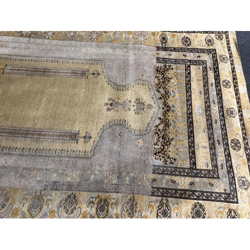 196 - A Turkish silk prayer rug, with mihrab and stylised foliate borders on a gold ground, 185 x 137cm... 