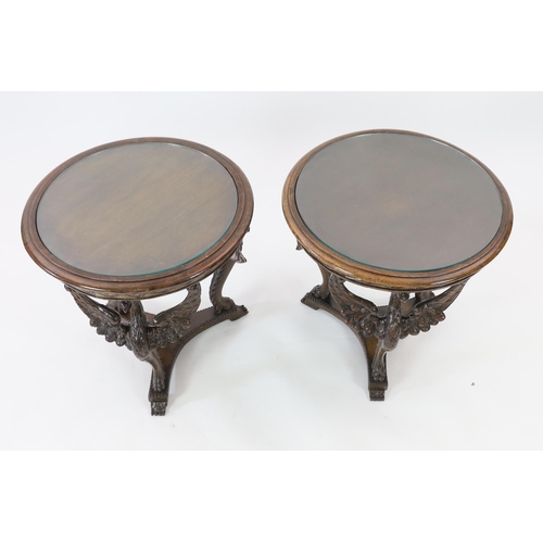 200 - A pair of walnut occasional tables with glass inset circular tops and triple winged eagle monopodia ... 