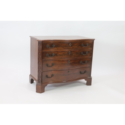 202 - A George III Chippendale serpentine mahogany chest of four graduated long drawers flanked by blind f... 