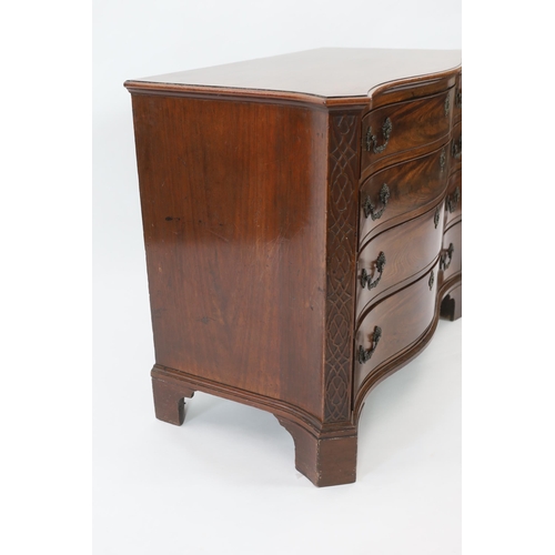 202 - A George III Chippendale serpentine mahogany chest of four graduated long drawers flanked by blind f... 