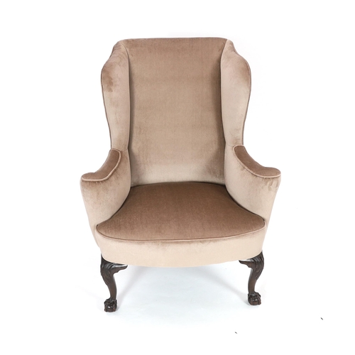 203 - A George II style mahogany wing armchair, upholstered in beige dralon, on acanthus carved cabriole l... 