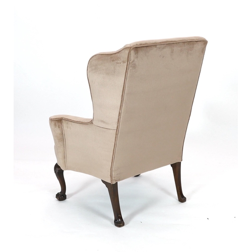 203 - A George II style mahogany wing armchair, upholstered in beige dralon, on acanthus carved cabriole l... 