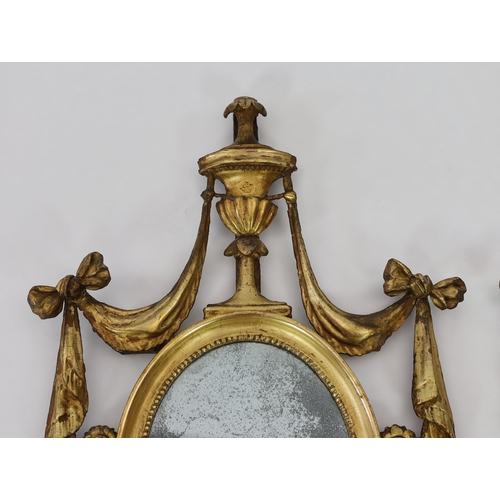 204 - A pair of late 18th century Adam period giltwood wall mirrors with urn and ribbon swag crests over o... 