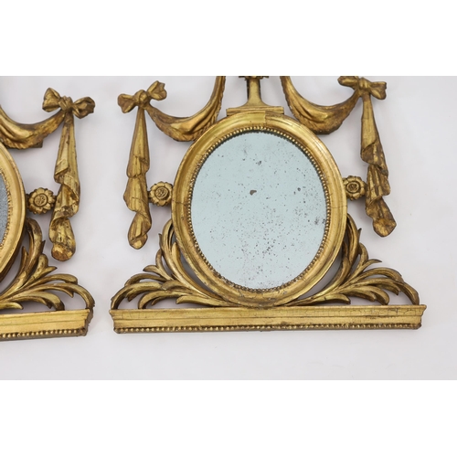 204 - A pair of late 18th century Adam period giltwood wall mirrors with urn and ribbon swag crests over o... 