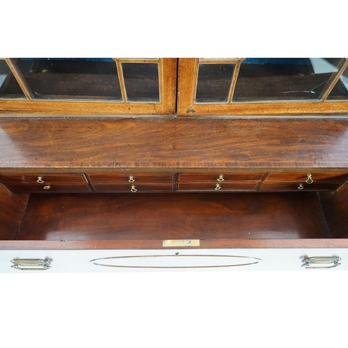 205 - A late George III mahogany secretaire bookcase, the moulded cornice with inlaid dentil work over two... 