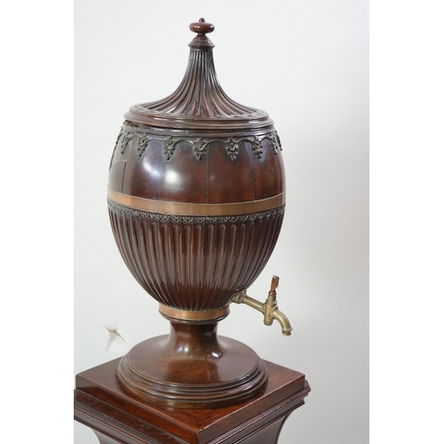 207 - An 18th century Dutch carved mahogany wine cooler and cover of urn form with brass tap, on bombé two... 