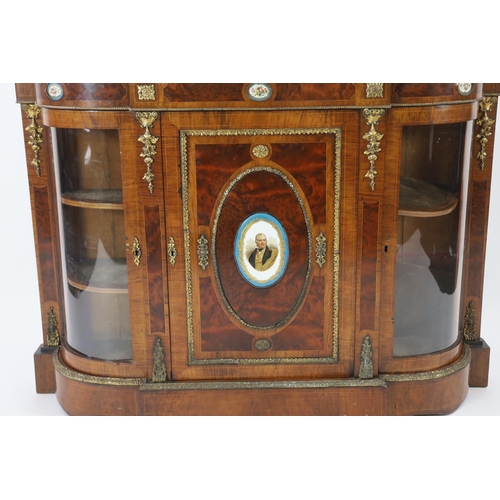 215 - A Victorian ormolu mounted walnut credenza of D shaped breakfront form applied with Sevres style pla... 