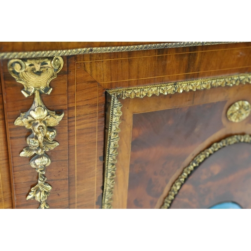 215 - A Victorian ormolu mounted walnut credenza of D shaped breakfront form applied with Sevres style pla... 