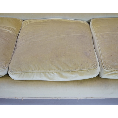 216 - A large Victorian sofa, in the manner of Howard & Sons, with faded velvet upholstery, on turned gold... 