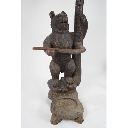 221 - A late 19th/early 20th century Swiss Black Forest carved wood hall stand, the mother bear depict... 