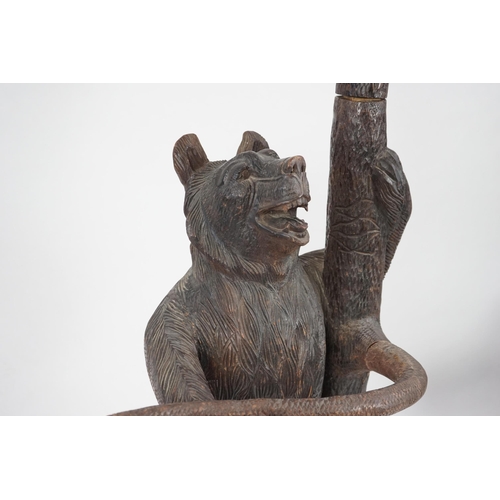 221 - A late 19th/early 20th century Swiss Black Forest carved wood hall stand, the mother bear depict... 