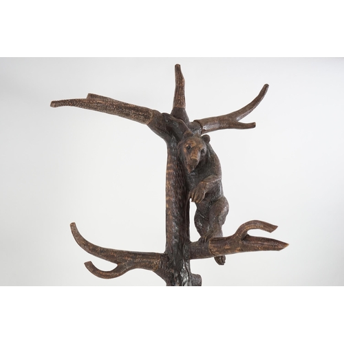 221 - A late 19th/early 20th century Swiss Black Forest carved wood hall stand, the mother bear depict... 