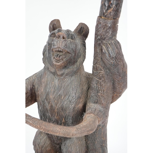 221 - A late 19th/early 20th century Swiss Black Forest carved wood hall stand, the mother bear depict... 