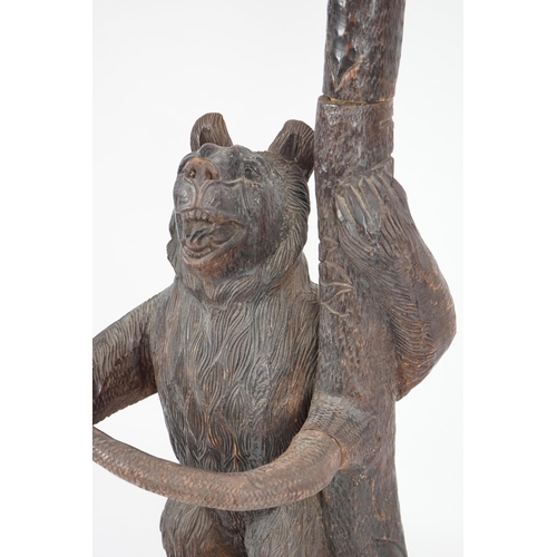 221 - A late 19th/early 20th century Swiss Black Forest carved wood hall stand, the mother bear depict... 