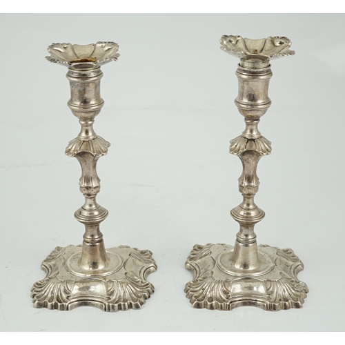 419 - A pair of George II cast silver candlesticks by William Gould, with knopped stems, on shaped square ... 