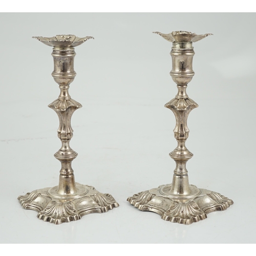 419 - A pair of George II cast silver candlesticks by William Gould, with knopped stems, on shaped square ... 