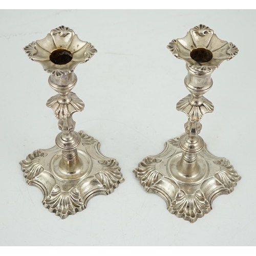 419 - A pair of George II cast silver candlesticks by William Gould, with knopped stems, on shaped square ... 