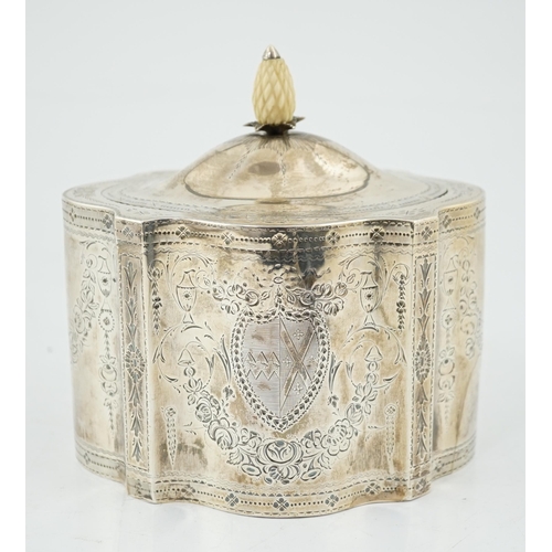 421 - A George III engraved silver tea caddy, by Benjamin Mountigue, of serpentine form, with carved ivory... 