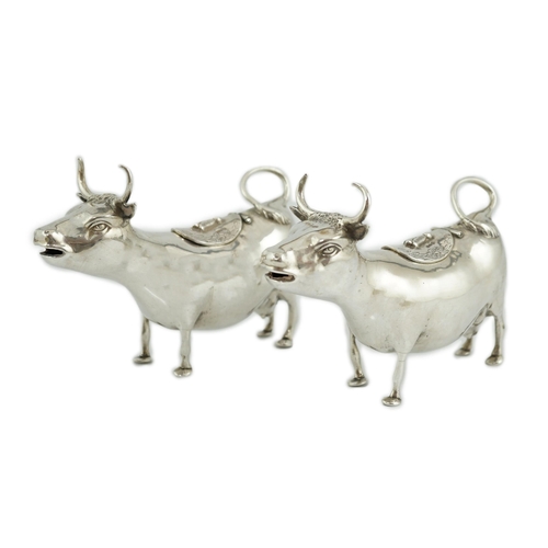 465 - A pair of early 20th century continental silver cow creamers, by Berthold Muller, the hinged covers ... 