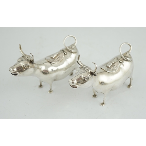 465 - A pair of early 20th century continental silver cow creamers, by Berthold Muller, the hinged covers ... 