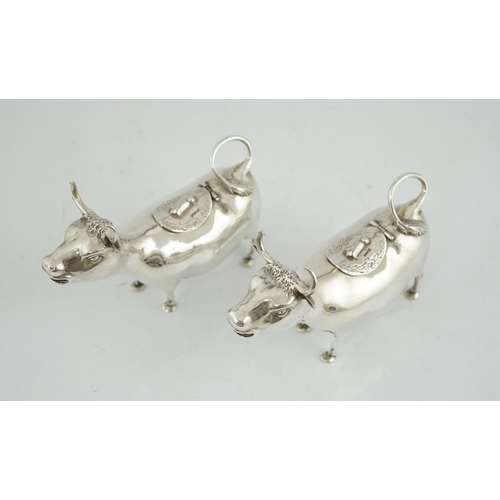 465 - A pair of early 20th century continental silver cow creamers, by Berthold Muller, the hinged covers ... 