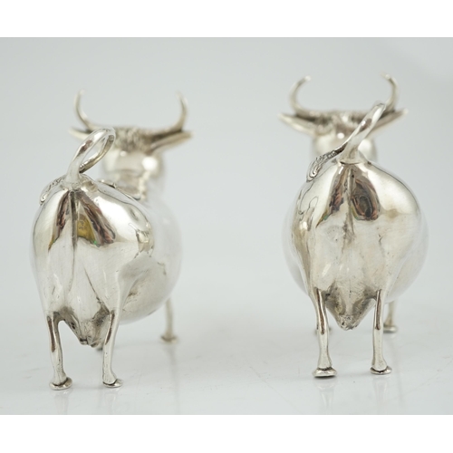 465 - A pair of early 20th century continental silver cow creamers, by Berthold Muller, the hinged covers ... 