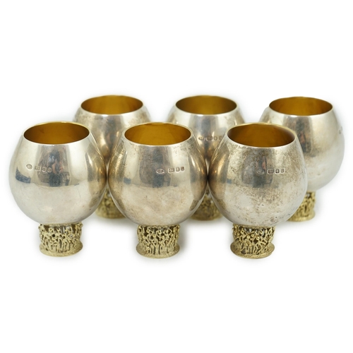 477 - A set of six Elizabeth II Stuart Devlin parcel gilt silver balloon shaped pedestal tots, the pierced... 