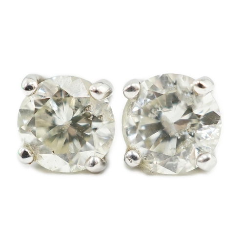 590 - A pair of 18k white gold and solitaire diamond set ear studs, the stone diameter approximately 5.4mm... 