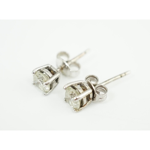 590 - A pair of 18k white gold and solitaire diamond set ear studs, the stone diameter approximately 5.4mm... 