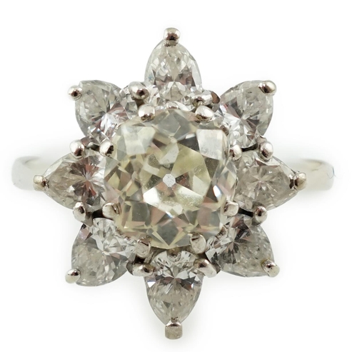 596 - A modern 18ct white gold and diamond flower head cluster ring, set with round and pear cut stones, t... 