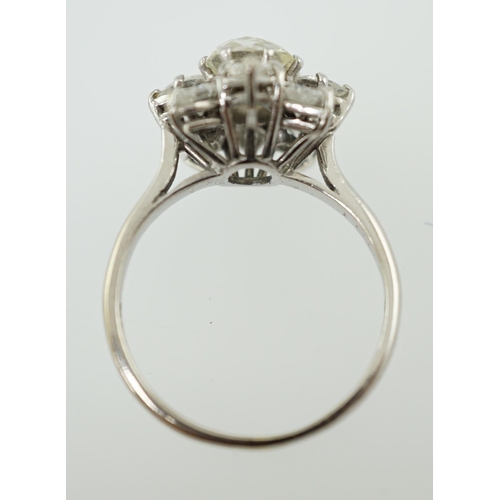 596 - A modern 18ct white gold and diamond flower head cluster ring, set with round and pear cut stones, t... 