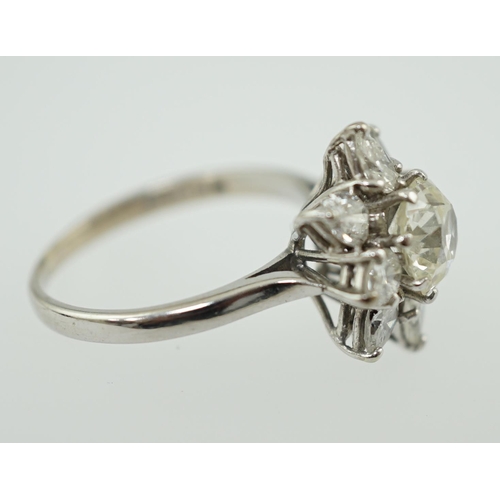 596 - A modern 18ct white gold and diamond flower head cluster ring, set with round and pear cut stones, t... 