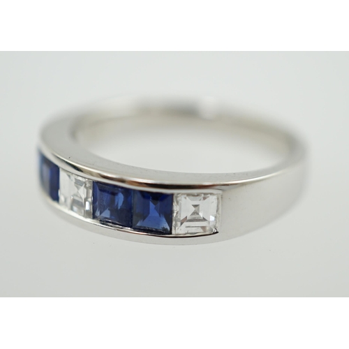 597 - A modern 14k white gold, three stone diamond and four stone sapphire half hoop ring, set with square... 