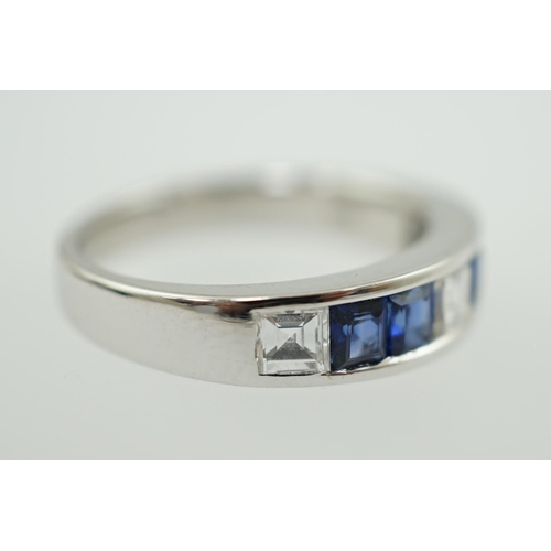 597 - A modern 14k white gold, three stone diamond and four stone sapphire half hoop ring, set with square... 