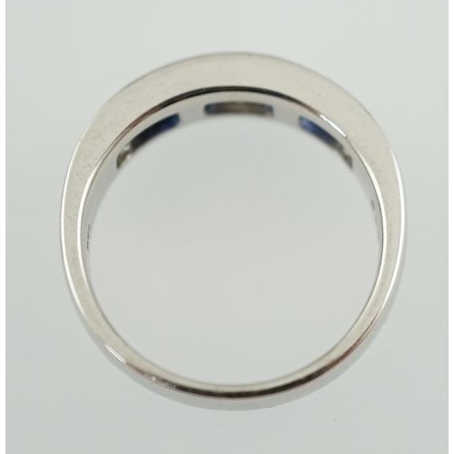 597 - A modern 14k white gold, three stone diamond and four stone sapphire half hoop ring, set with square... 