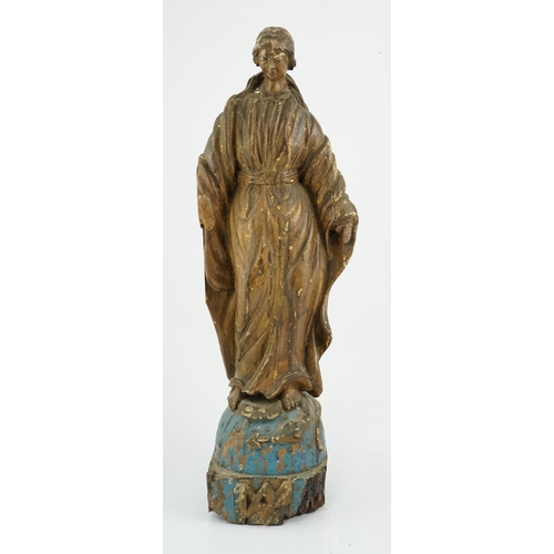 6 - An 18th century Continental carved wood figure of a female saint, with gilt and painted decoration, ... 