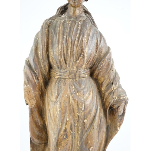 6 - An 18th century Continental carved wood figure of a female saint, with gilt and painted decoration, ... 