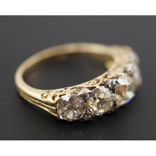 602 - A Victorian 18ct and graduated five stone old round cut diamond set half hoop ring, with diamond chi... 