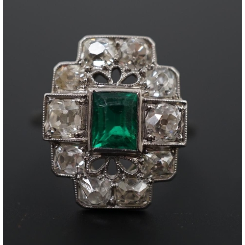 604 - An early to mid 20th century white gold?, emerald and diamond cluster set stepped oval dress ring, w... 