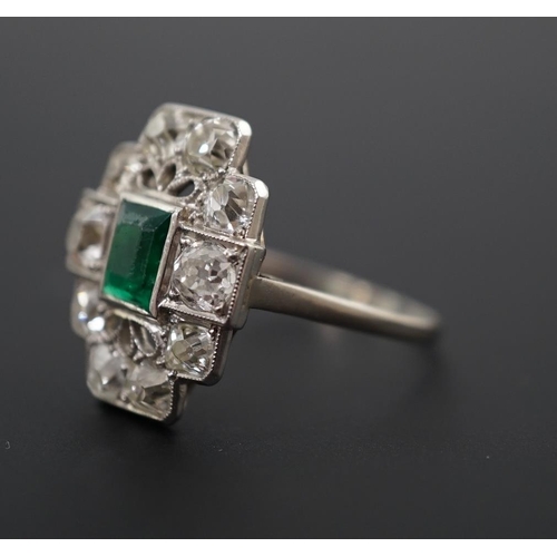 604 - An early to mid 20th century white gold?, emerald and diamond cluster set stepped oval dress ring, w... 